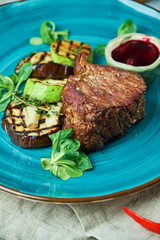 Steak with barbecue vegetables and lingonberry sauce