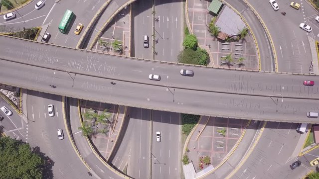 Slow descending shot of roundabout with big traffic in summer day