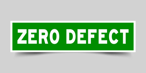 Square green sticker label in word zero defect on gray background