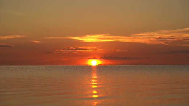 Colorful sunset over calm sea water near tropical beach. Summer vacation concept. Island Koh Phangan, Thailand