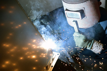 Arc welding work at a back street factory in Japan: Welding while protecting with handle welding mask