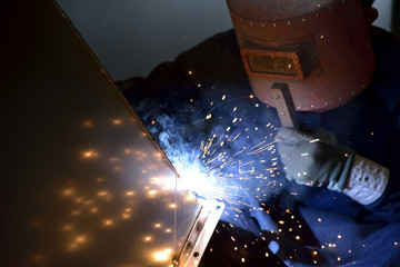 Arc welding work at a back street factory in Japan: Welding while protecting with handle welding mask