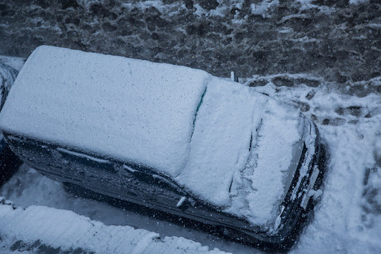 Car covered with a thick layer of snow,top angle. Concept: winter weather and car owner confrontation - Image