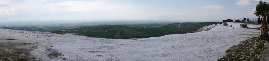 Fototapeta na wymiar Panoramic view of the beautiful white Travertines terrace of Pamukkale landscape