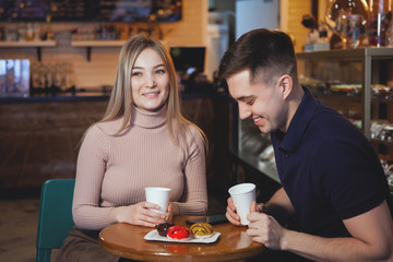 Two cute young boy and girl in a cafe.