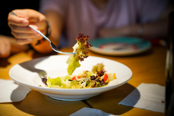 a woman eating fruit salad