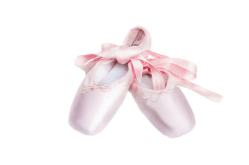 Pointe shoes ballet dance shoes with a bow of ribbons beautifully folded on a white background.