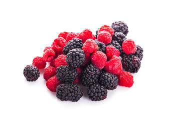 Raspberries and blackberries on white background