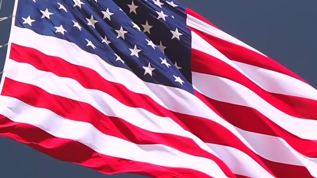 Static slow motion shot, close up, of American flag, the Stars and Stripes, waving in the wind, in United states of America
