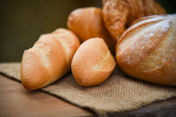 bread and buns assortment / Fresh Bakery bread various types on sack in the rustic table homemade breakfast food