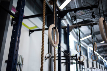 Closeup of Gymnastic rings in a large gym 