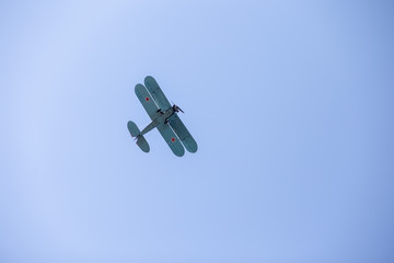 old military aircraft flying through the blue sky