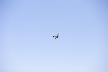 old military aircraft flying through the blue sky