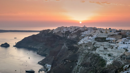 wide view of sunset and the village of oia on santorini