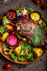 fried pork with vegetables and sauce on the plate