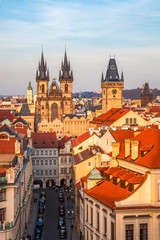 Naklejka na ściany i meble Warm evening light falls on Prague and its Tyn Church