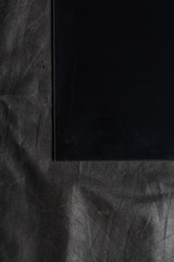 paper shit on dark grey textile background 