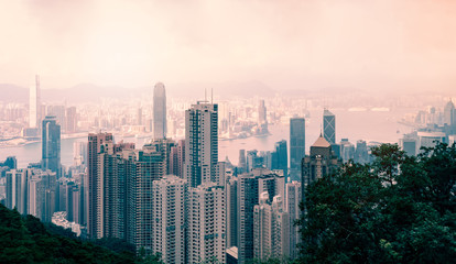 Hong Kong cityscape in the evening with beautiful sunset and mist , View from victoria peak