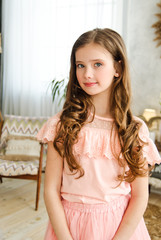 Fototapeta premium Portrait of adorable smiling little girl child schoolgirl in princess dress with curl hair
