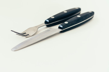 Close up knife and fork isolated on white background.