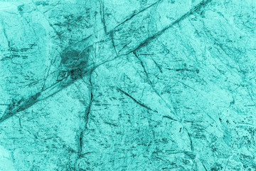 Vintage azure background. Rough painted wall of turquoise color. Imperfect plane of cyan colored. Uneven old decorative toned backdrop of aqzure tint. Texture of teal hue. Ornamental stony surface.