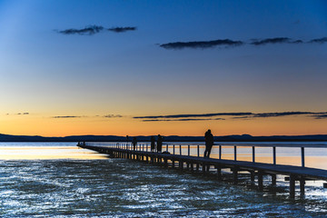 Fototapeta premium Silhouettes and Sunset at Long Jetty