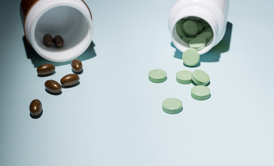 green and brown pills on a blue background