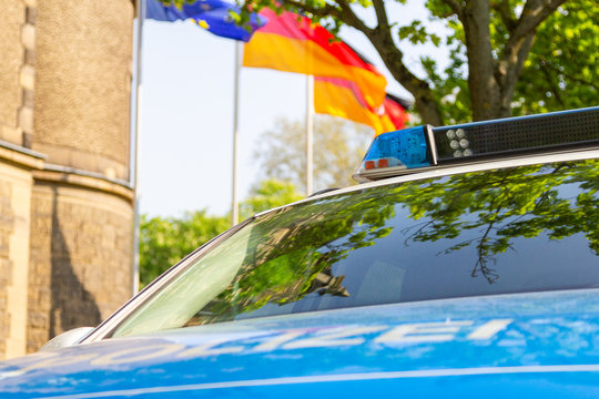 German Police Car Stands In Front Of A Police Department. The German Word Polizei Means Police.