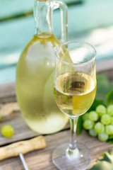 Wine background, wine concept. White wine bottles on wooden table. Outdoor still life in the vineyard.