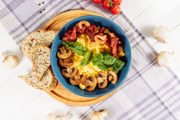 Polenta Italian Corn Porridge Mushroom Flat Lay. Traditional Healthy Breakfast Cuisine with Roasted Pork Bacon in Bowl Top Down View. Yellow Cornmeal Gourmet Serving with Salad Leaf and Bread Overhead