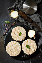 Raw fresh cutlets burger from beef for homemade burgers cooking with spices on black board. Top view.