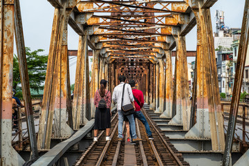 Railways on Long Bien ancient metal bridge with people taking photo on railways