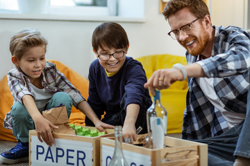 Laughing bearded tutor being satisfied with intense work of his pupils