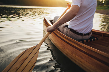 Close up of canoeist with wooden canoe paddle
