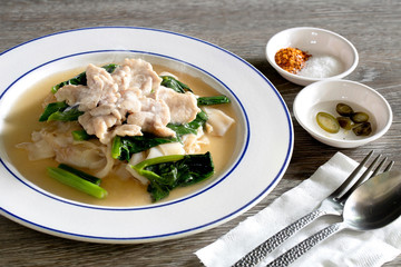Noodle topping in white dish with seasoning