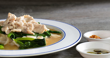 Noodle topping in white dish with seasoning