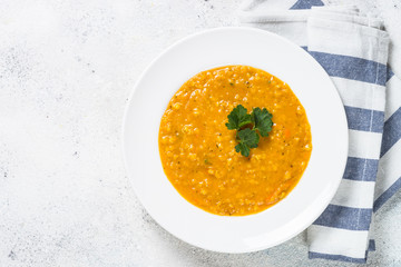 Red lentil soup on white top view.