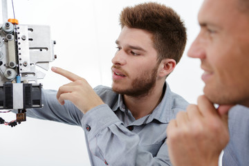 robotics engineer inspecting a machine