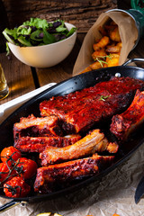 Grilled ribs in spicy marinade with salad and vegetables