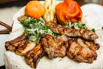 Barbecue, cooked different meat with grilled vegetables