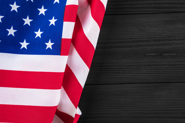 Fototapeta na wymiar American flag on a black wooden