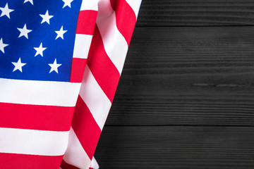 Fototapeta premium American flag on a black wooden