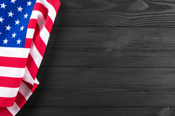 Fototapeta premium American flag on a black wooden