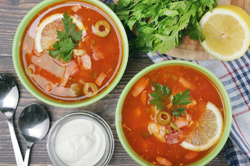 Two bowls with traditional Russian soup solyanka