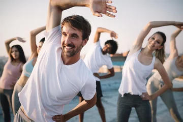 Zelfklevend Fotobehang Fitness, sport, friendship and healthy lifestyle concept . Group of happy people exercising © NDABCREATIVITY