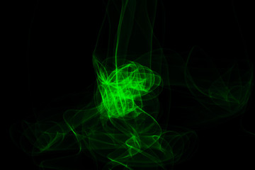 Green neon intertwined smoke. Abstract black background. Neon lights texture.