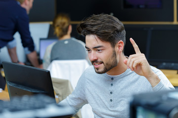 student using computer with finger raised