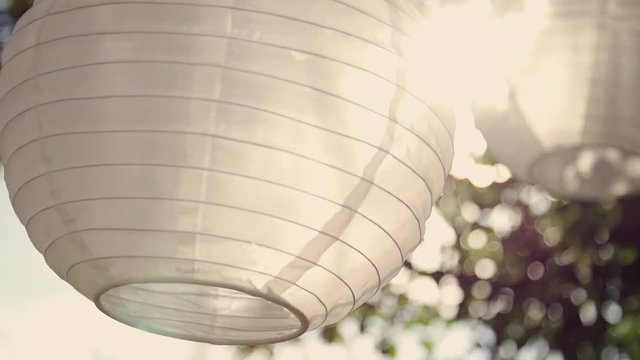 white round laterns hanging in sunlight