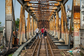 Railways on Long Bien ancient metal bridge with people taking photo on railways