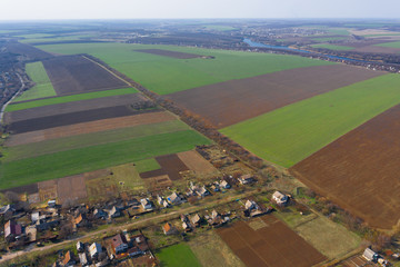 Airbrush photography of a green field from a height. Blue sky.